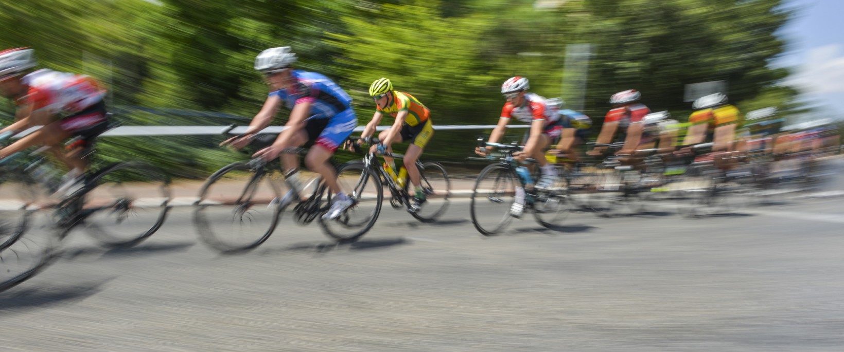 peloton of bicycle riders in a race in motion